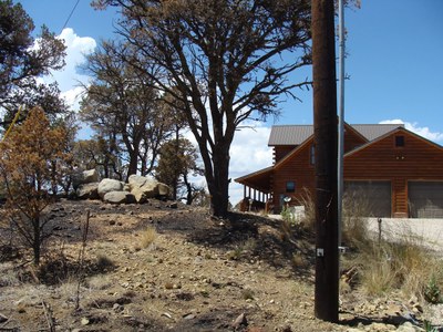 Home with Defensible Space, Little Bear Fire. Courtesy of NM State Forestry. Photo by Frank Silva.